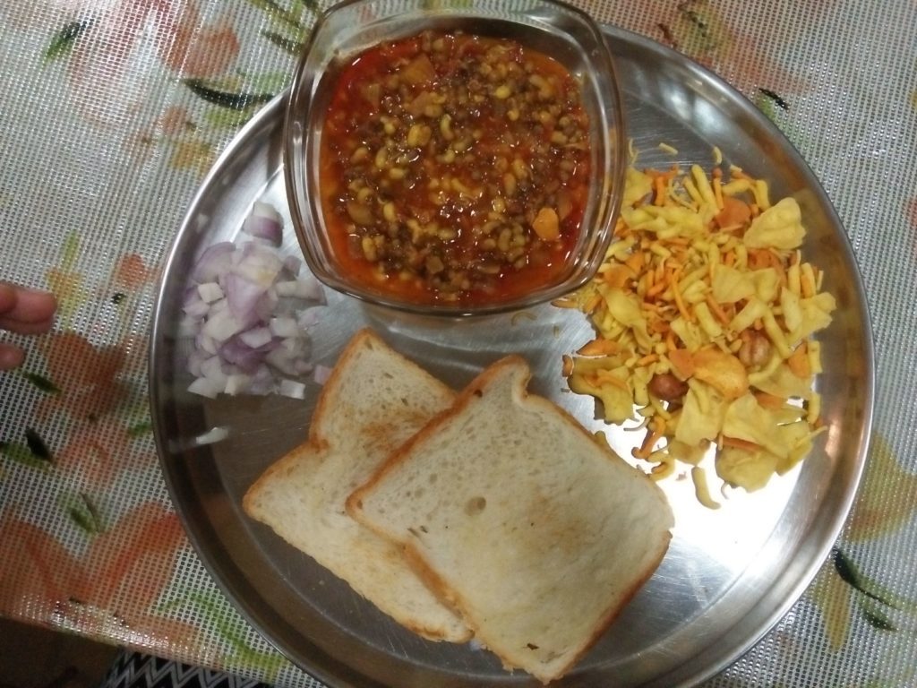 Math Misal served with Pav and Farsan and raw onions