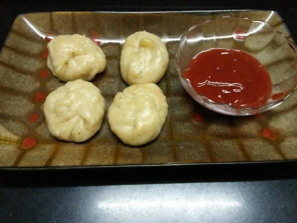 Steamed momos  served with Tomato Ketchup. An Indian fusion Recipe