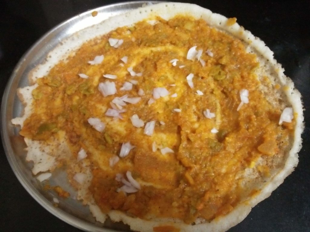 Pav Bhaji Dosa topped with Bhaji and Onions
