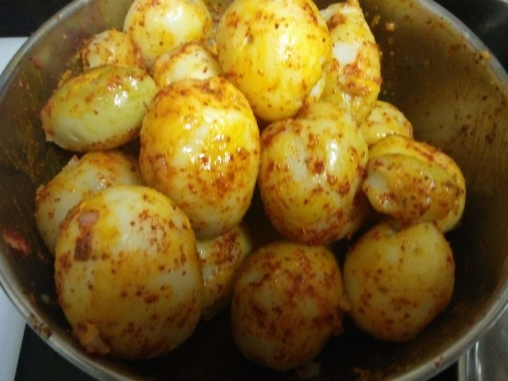 Baby potatoes coated with turmeric, red-chili powder and oil for the North Indian Subzi, Dum Aloo