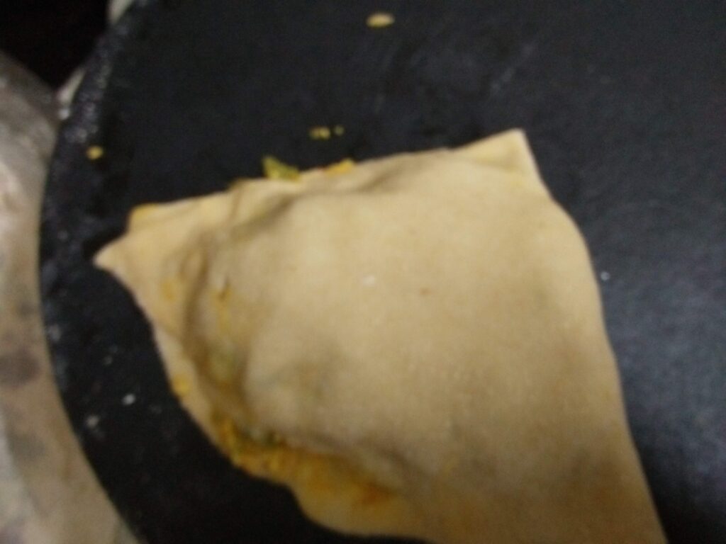 Paratha folded in a triangle shape