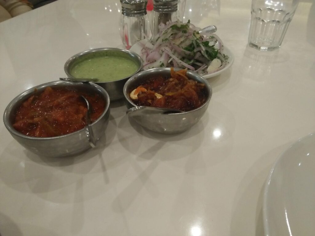 Pickles, mint Chutney and onions served with the meals at Samrat Restaurant in Mumbai