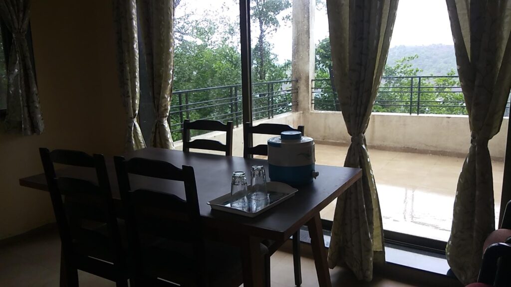 DINING AREA AND A HUGE BALCONY AT LAKE VIEW PREMIERE SUITES AT MTDC BHANDARDARA